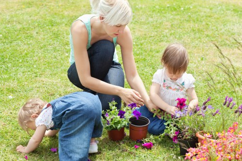 Gardening crew discussing a free written quote in a residential garden
